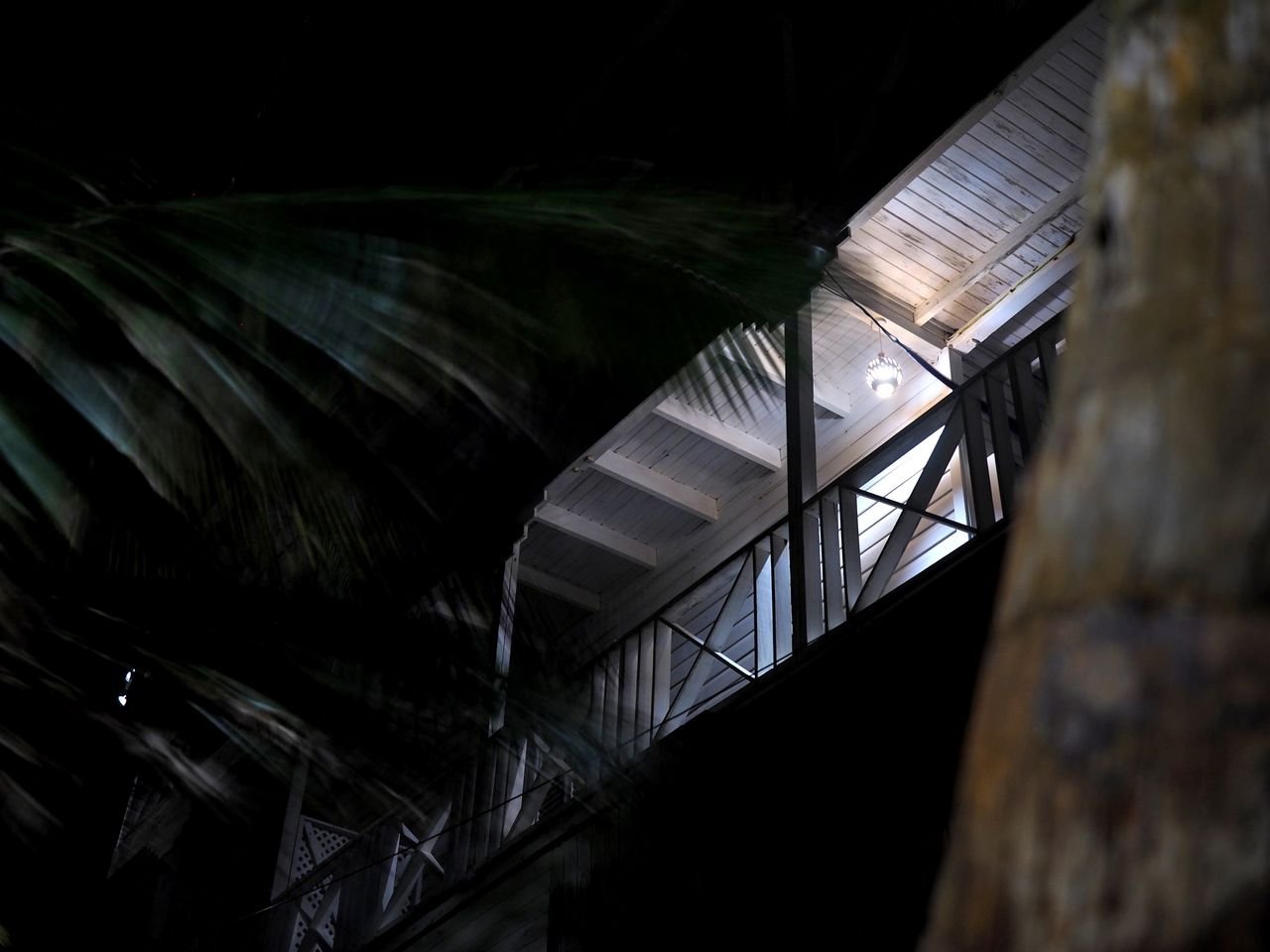 A modern house in Barbados at night, illuminated with ambient lighting.