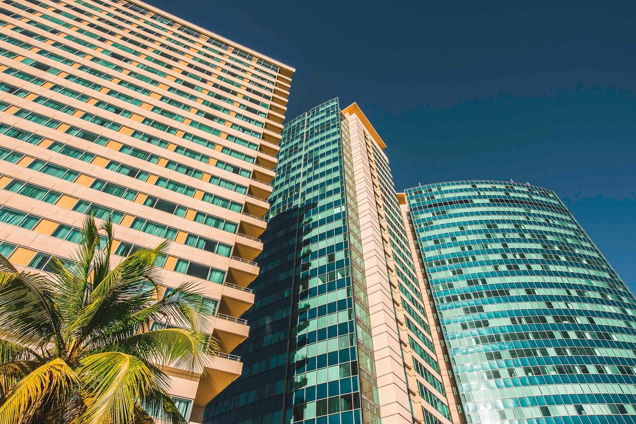 Low angle view of modern skyscrapers against a clear blue sky in Port of Spain, Trinidad.